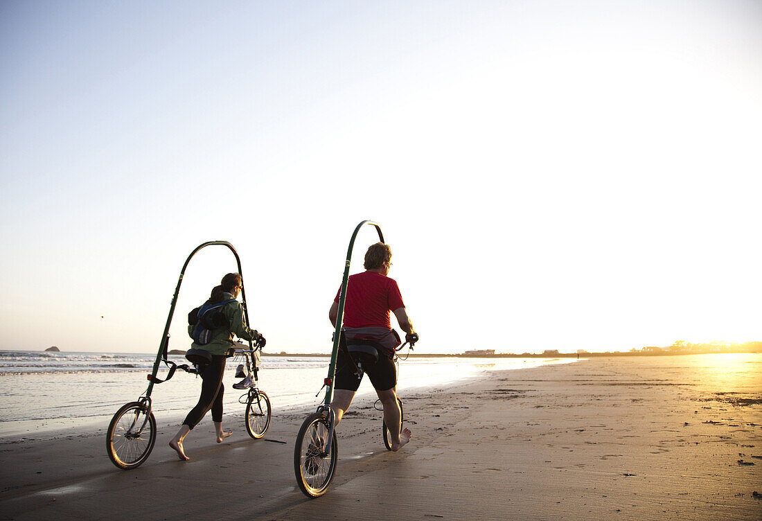 CRESCENT CITY, CALIFORNIA, USA. A man and a woman glide on a new prototype bicycle which causes less impact and can be used by the handicapped.