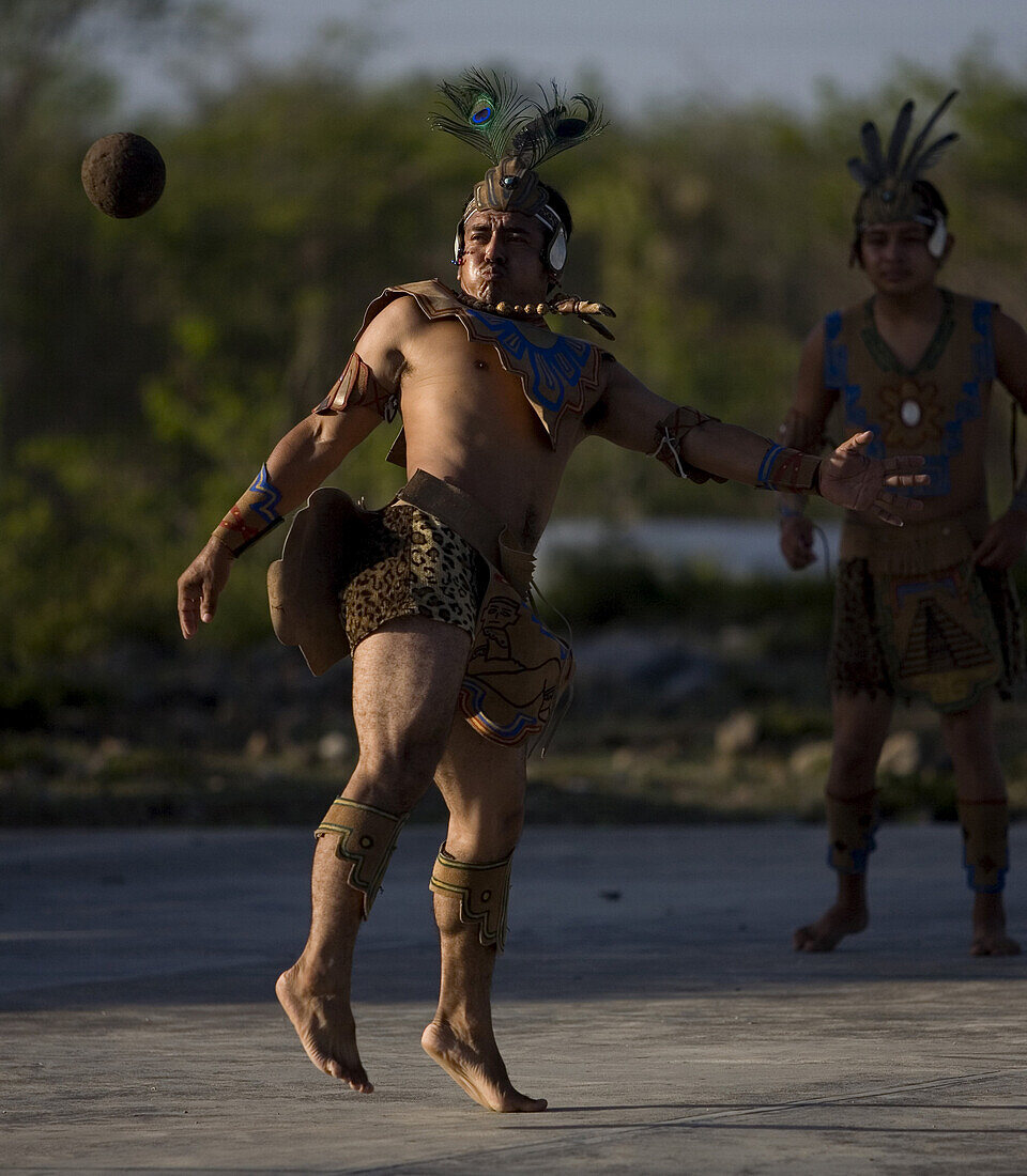 A Mayan ball game player hits the ball with the hip as he plays in Chapab village in Yuctatan state on Mexico's Yucatan peninsula, June 14, 2009.