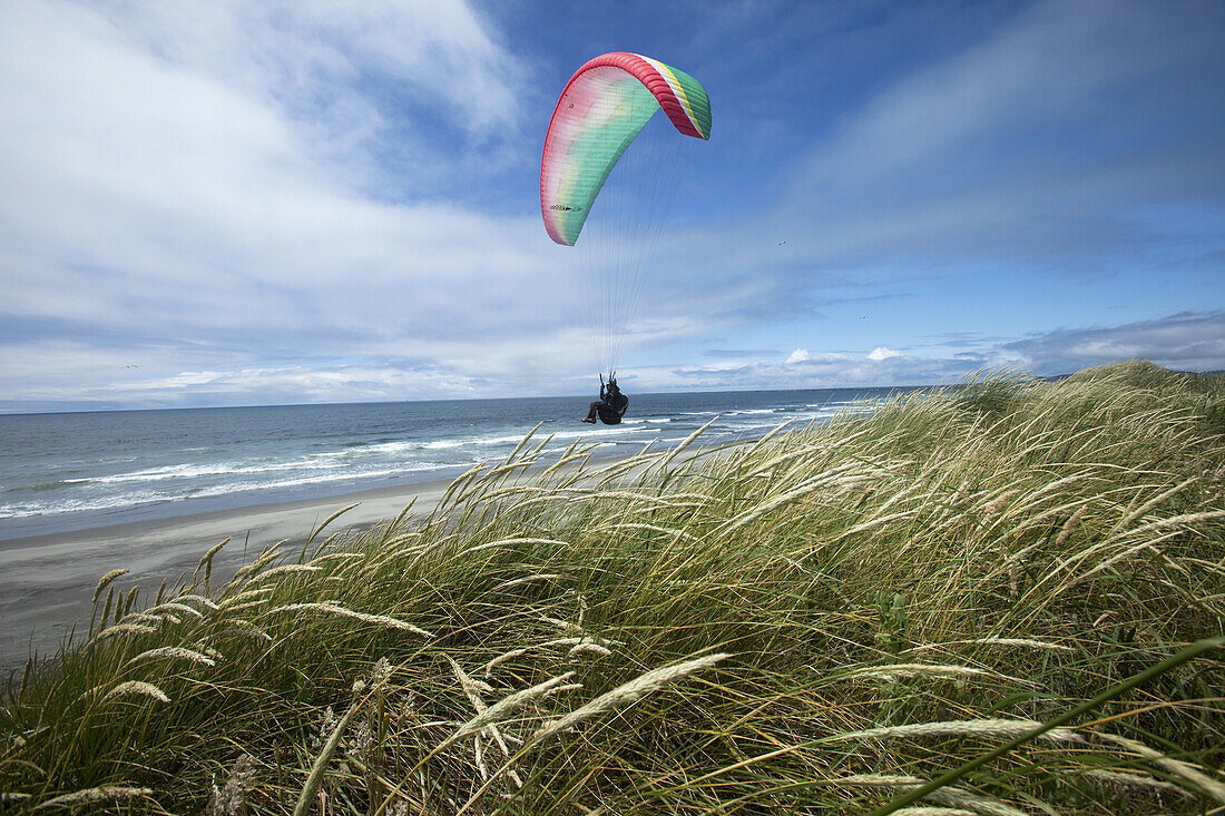 Maren Ludwig paragliding over the dunes at Area B in Fort Stevens State Park in Warrenton, Oregon.