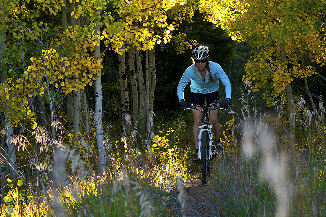 Heather Swallow enjoys an evening mountain bike ride on a beautiful Fall evening near Gold Hill, CO.