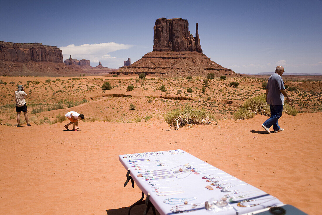 Tourists pass tables of Navajo crafts at Monument Valley Navajo Tribal Park in southern Utah. The park, operated by the tribe, was once a popular set for western films of the 1930s through 60s. It is immensely popular among European tourists.
