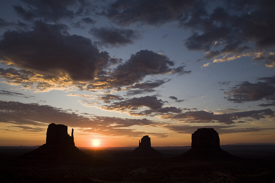 The sun rises over the most photographed view at Monument Valley Navajo Tribal Park in southern Utah. The park, operated by the tribe, was once a popular set for western films of the 1930s through 60s. It is immensely popular among European tourists.