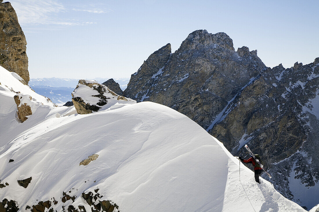 A male skier climbs a ridge near the top Garnet Canyon towards during a stellar day of touring in the Grand Teton National Park, Wyoming.