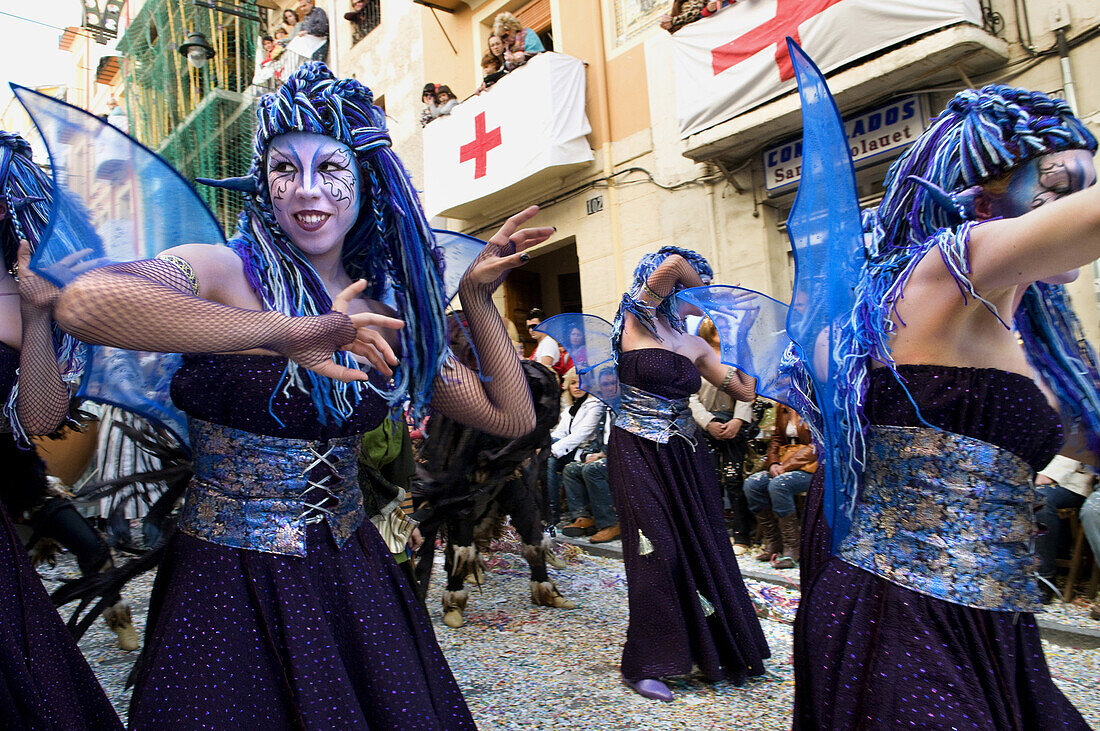 Women in fanciful costumes, loosely representing the North African tribes, the Moors, dance while marching in a parade during the Festival of Moors and Christians, La Fiesta de Moros y Cristianos, in the old town of Alcoy, Alicante Province, Valencia Auto