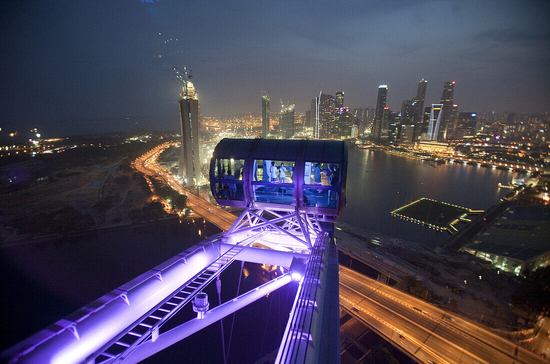 'The Singapore Flyer, a 42 story high observation wheel, was built to give tourists a 360 degree view of Singapore during a 30 minute ''flight'' in the safety and comfort of individual air conditioned cabins which each weight 16 tons and can hold up to 28