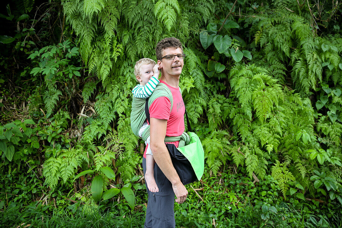 Father hiking with his son, boy 3 years old, tropical rain forest, walking, family travel in Asia, parental leave, German, European, MR, Munduk, Bali, Indonesia
