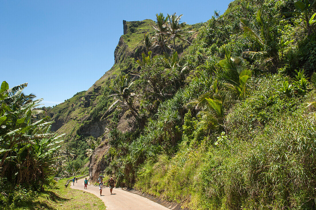 People walking on a pathway through a tropical forest, Pitcairn, Pitcairn Group of Islands, British Overseas Territory, South Pacific