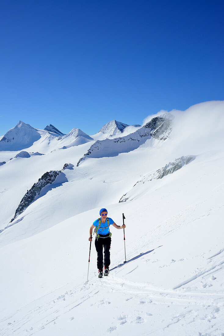 Female back-country skier ascending to Schlieferspitze, Venediger Group, High Tauern National Park, Salzburg, Austria