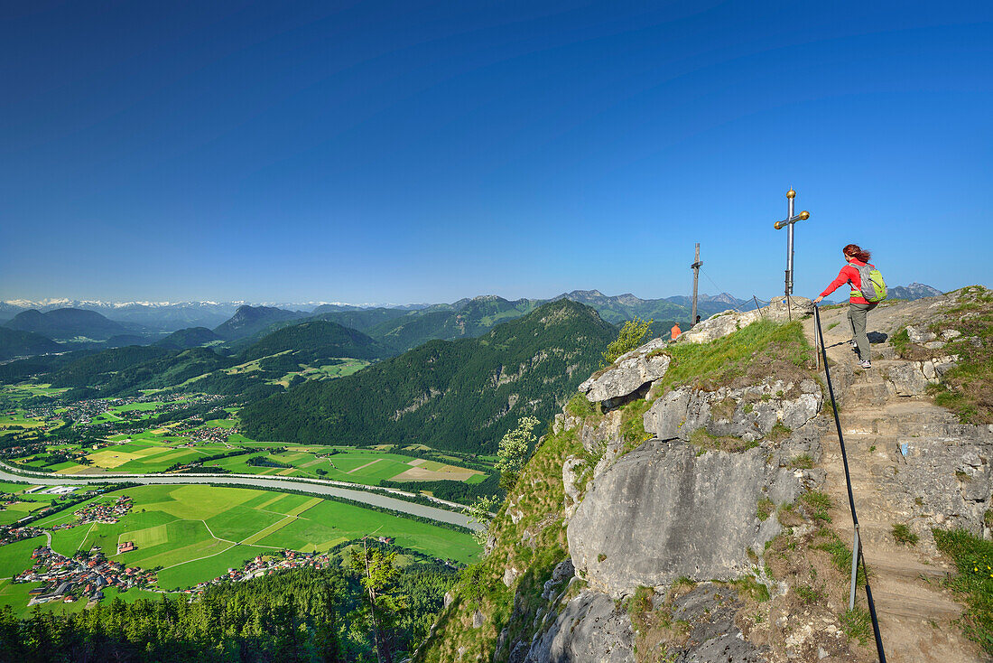Woman ascending to summit of Kranzhorn, Inn valley in background, Chiemgau Alps, Tyrol, Austria