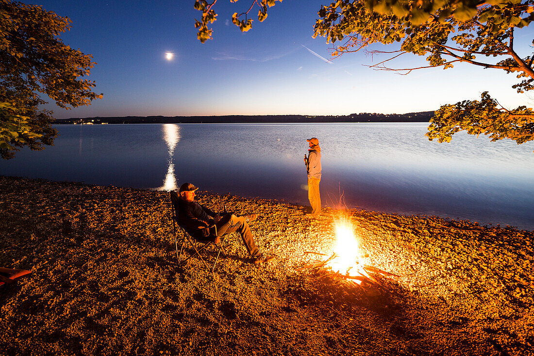 Two men at a campfire, Lake Starnberg, Berg, Upper Bavaria, Germany