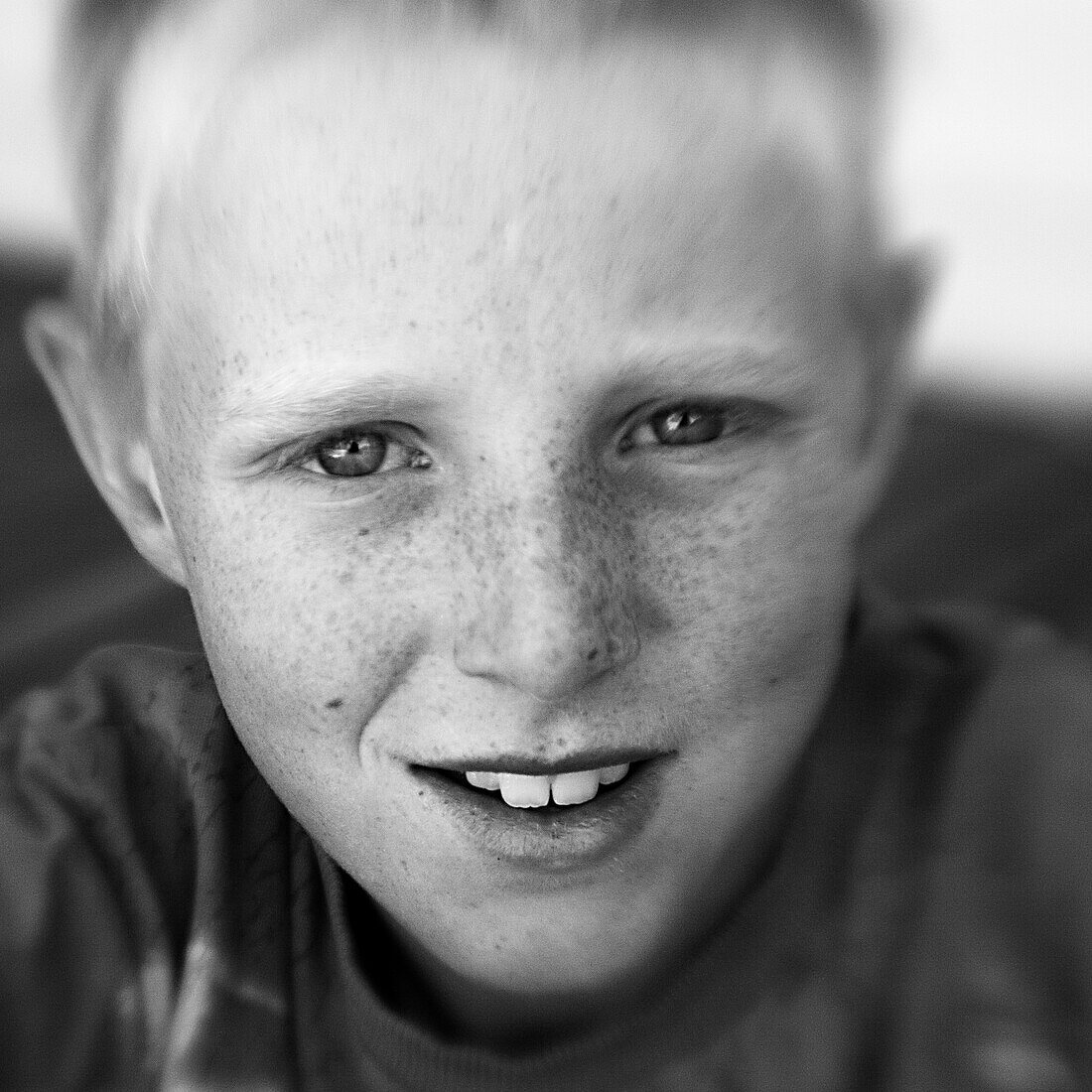Boy with freckled face looking into the camera (black and white photo using Lensbaby technique), Borden, Western Australia, Australia