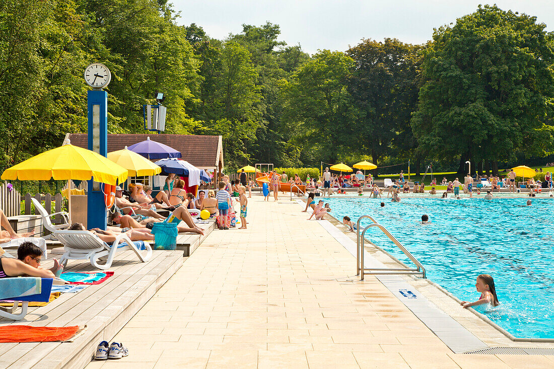 People enjoying a sunny afternoon at the outdoor swimming pool Heloponte, Bad Wildungen, Hesse, Germany, Europe