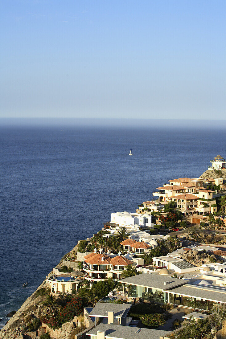 Sunrise light bathes the exclusive luxury villas that cling to the steep desert mountainsides in the Pedregal Hills overlooking the Pacific Ocean in Cabo San Lucas in Baja, Mexico. Photo by Harrison Shull/Aurora