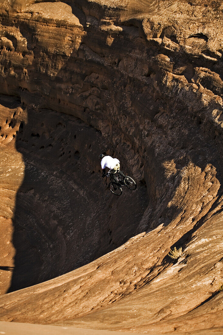Mountain biker riding in the Bartlett Wash area, Moab, Utah.