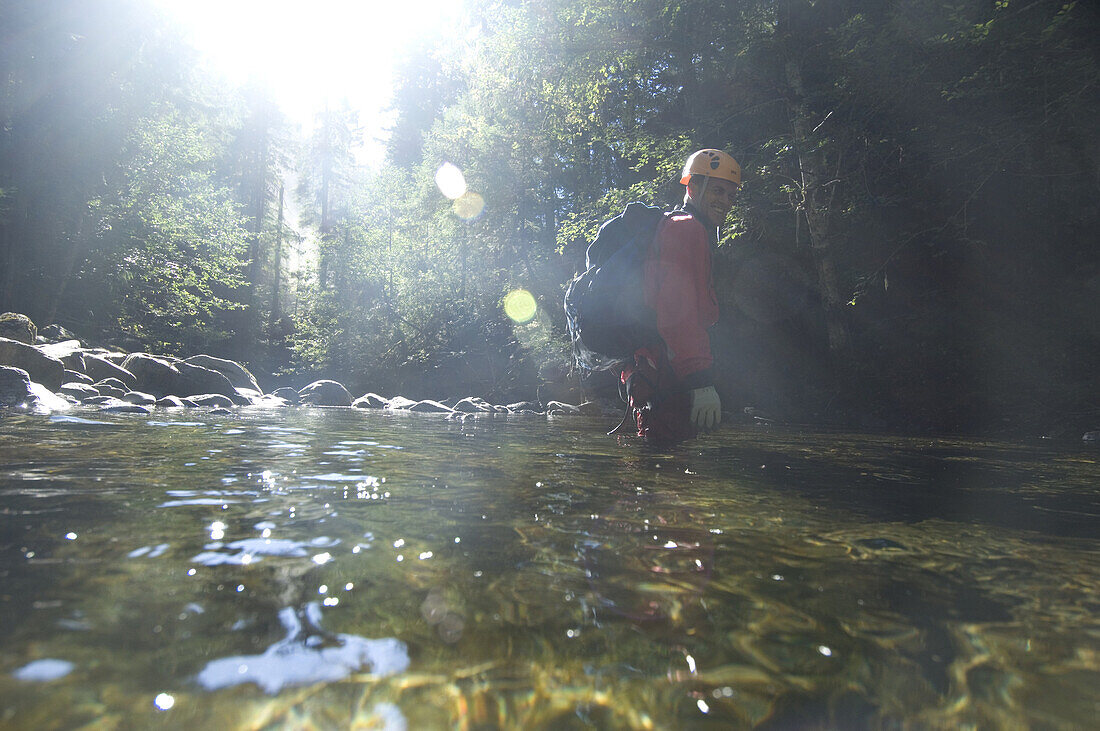 Canyoning is a new sport that consists in travelling down river canyons by walking, gliding, climbing, rappelling abseiling, swimming or jumping. Joe Budgen in easy water in Summit Creek canyon, Summit Creek, Gifford Pinchot National Forest, WA.