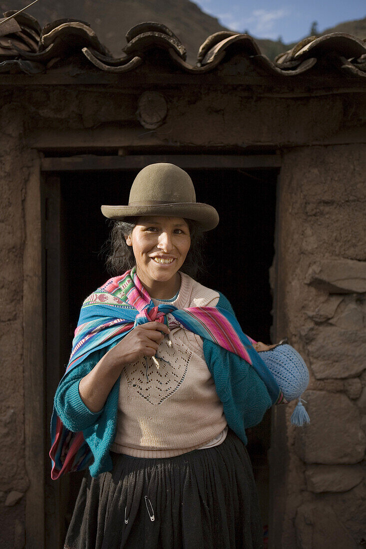PISAC, PERU - AUGUST 16:  A Quechua woman is photographed in front of a rustic local bar in Pisac, Peru on August 16, 2006. Photo by Dennis Drenner/Aurora