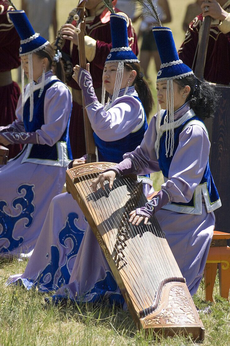 Mongolian musicians play traditional instruments and music at a summer festival at the Dinosaur ger camp in Gorkhi-Terelj National Park. During summer festivals, traditional Mongolian music and dance are performed throughout the country.