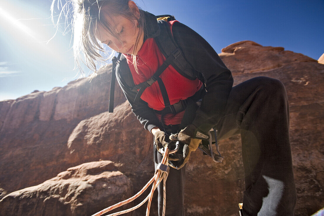 Briana Ratterman setting up a rappell, Lomatium canyon loop in the Fiery Furnace, Arches National Park, Utah.