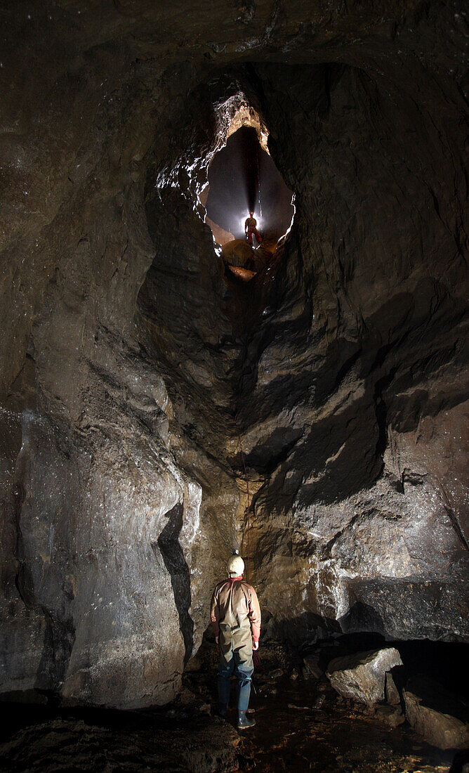 Self portrait in a section of cave with a large ramp leading up to a vertical section of cave in Speedwell Cavern called Block Hall in England.