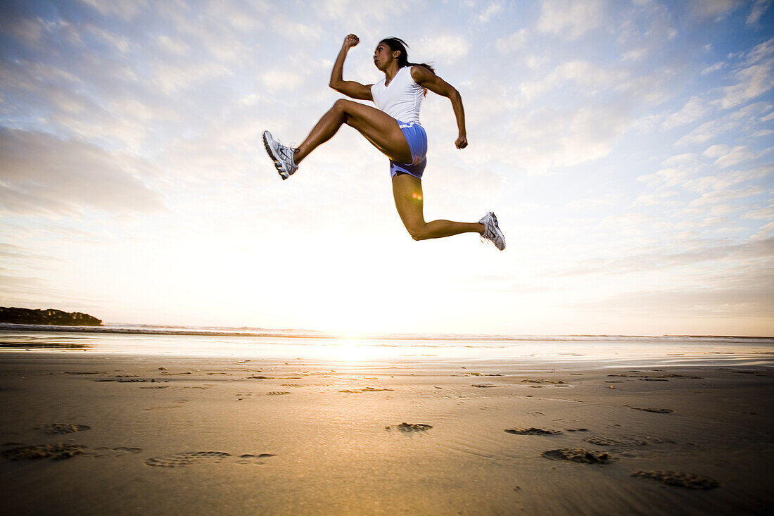 A woman runs in athletic gear in Oceanside, California.