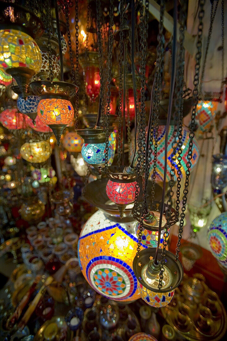 A small shop in the Grand Bazaar Kapali Carsi, is host to many traditional stained glass lamps that hang from the ceiling. Istanbul, Turkey.