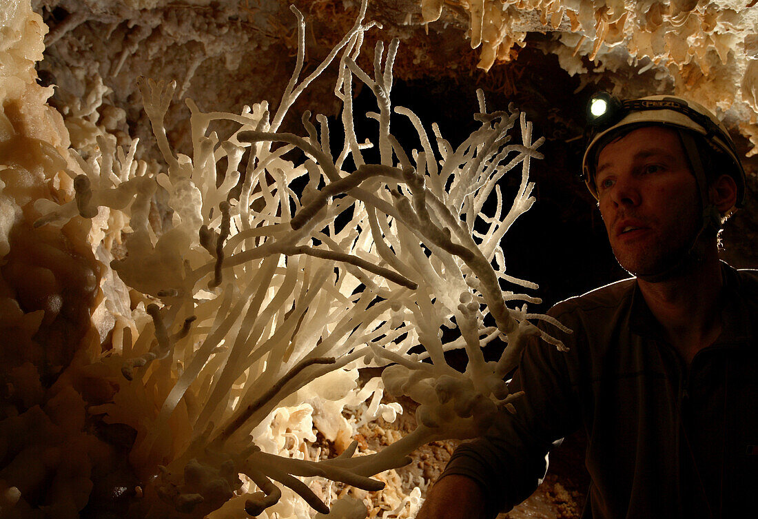 British cave explorer Dave Nixon admires this stunning and remarkable crystal formation, deep underground in Whiterock cave, Mulu National Park in Sarawak Borneo, February 11, 2007. Dave Nixon was part of a group of British explorers that mapped an additi