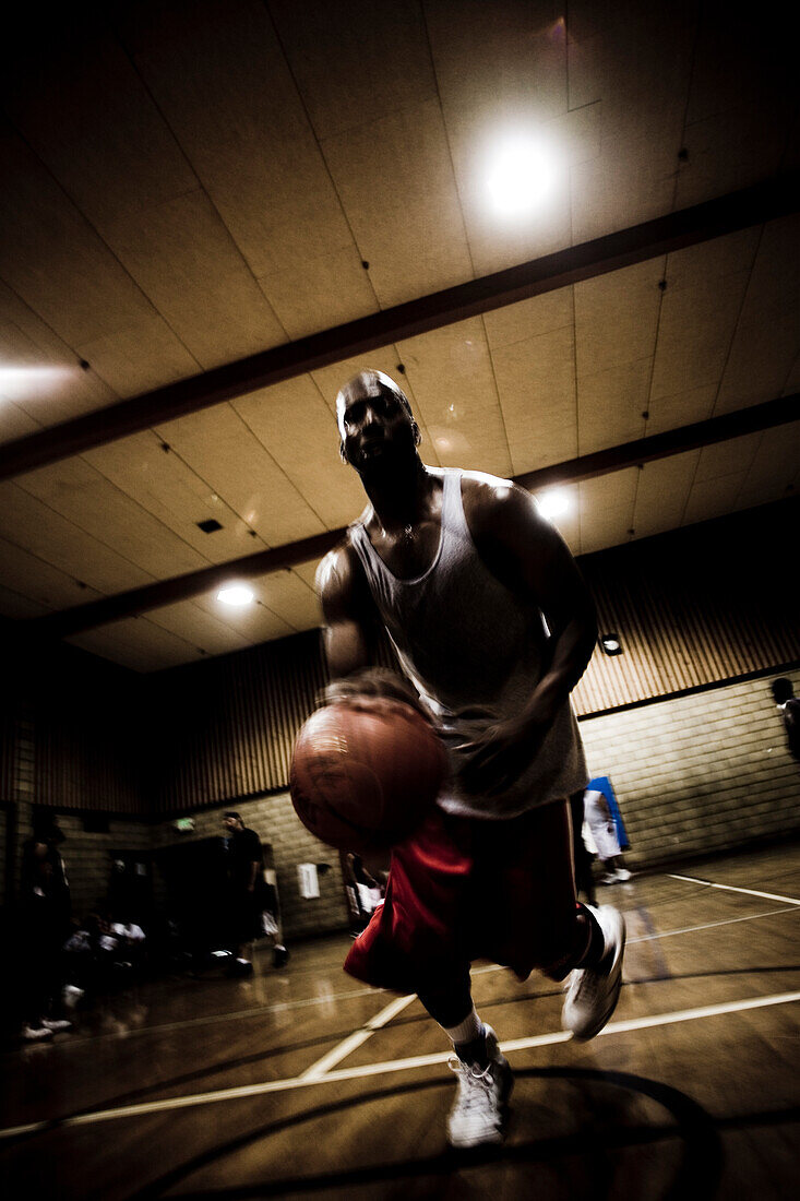 A basketball player is driving for the hoop.