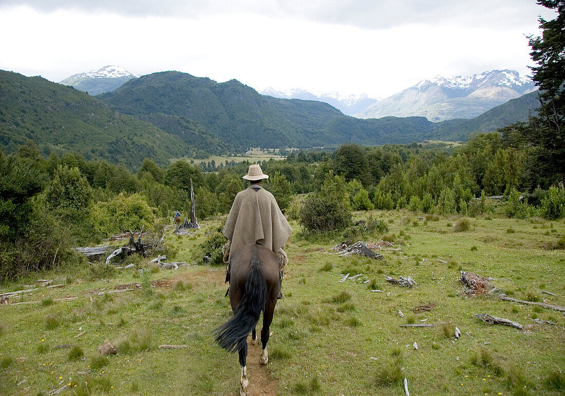 Omer Thompson horse treks through Futaleufu, Chile.