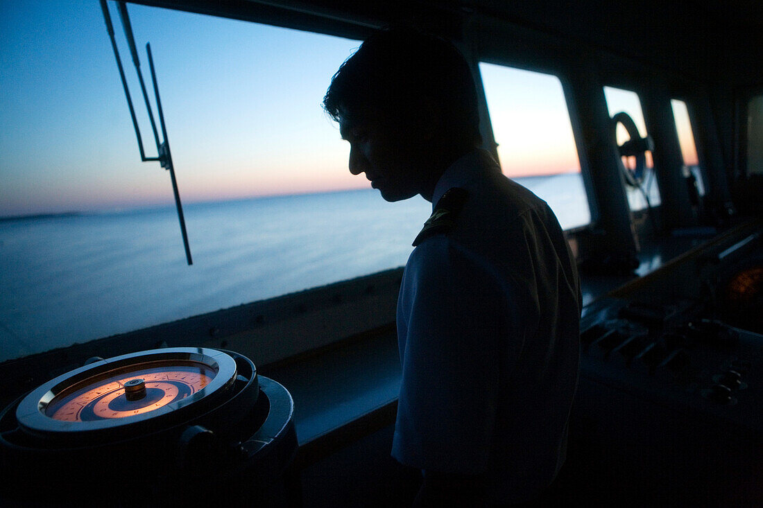'BALTIMORE, MARYLAND -- MAY 6:  A crew member looks over one of the compasses onboard the Japanese car carrying ship ''Singa Ace'' as it makes its way down the Chesapeake Bay on its way to Baltimore Harbor on May 6, 2007.   Photo by Dennis Drenner/Aurora,