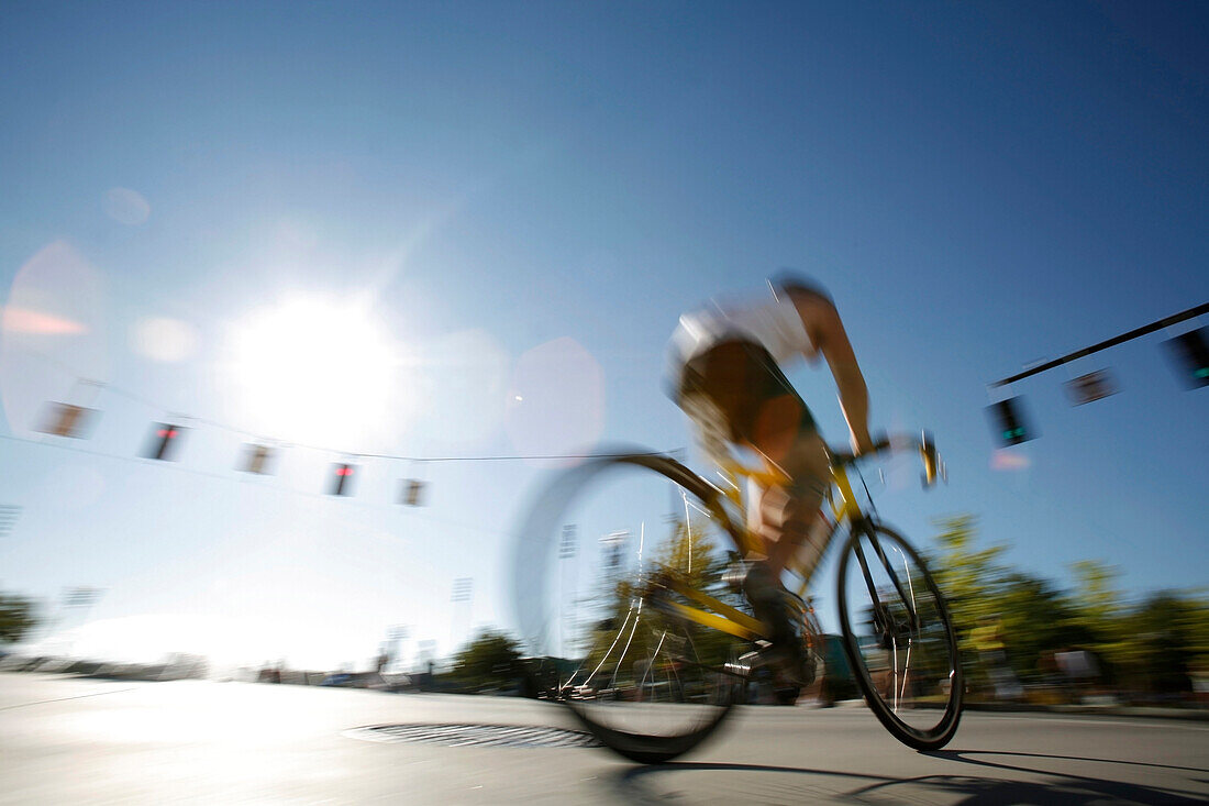 Male triathlete races bicycle during first annual 2007 Portland Triathlon in Portland, Oregon.  The race is carbon neutral.