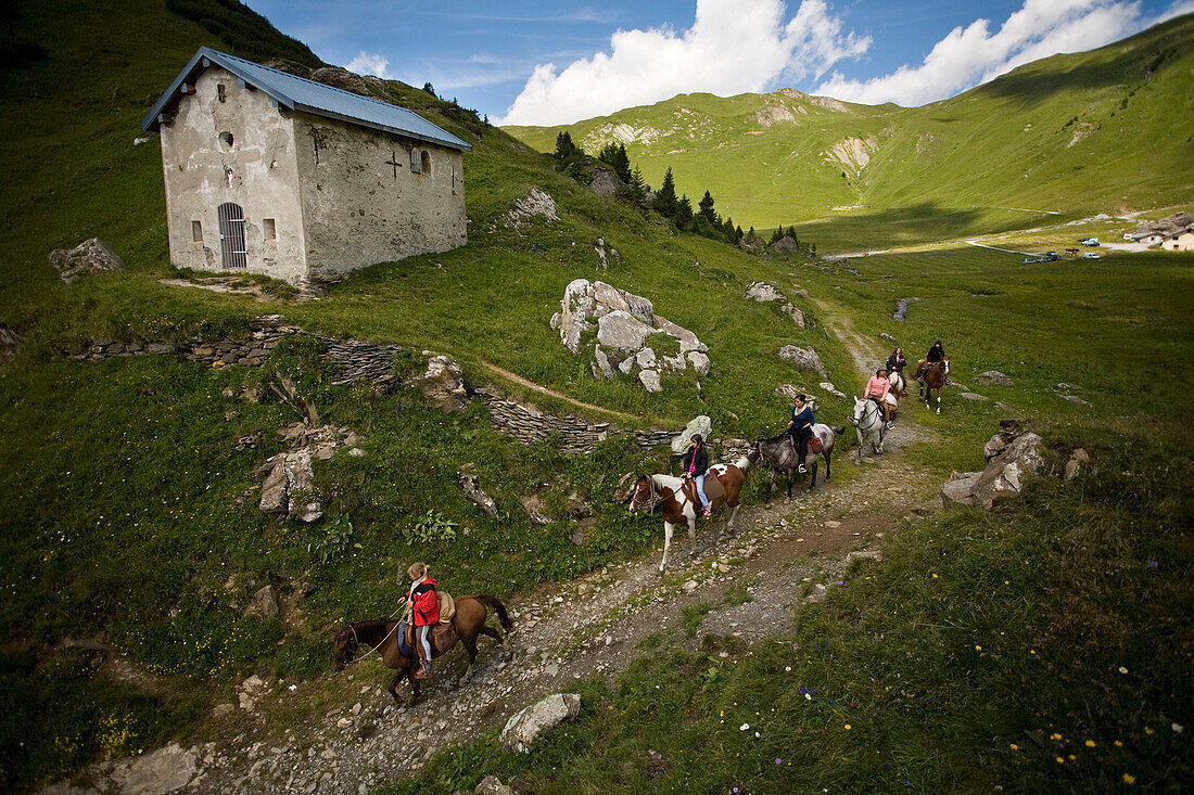 ALPS, SAVOIE, FRANCE-SEPTEMBER 12, 2007: Girls riding horses on a promenade through the French Alps in Savoie, France on September 12, 2007.