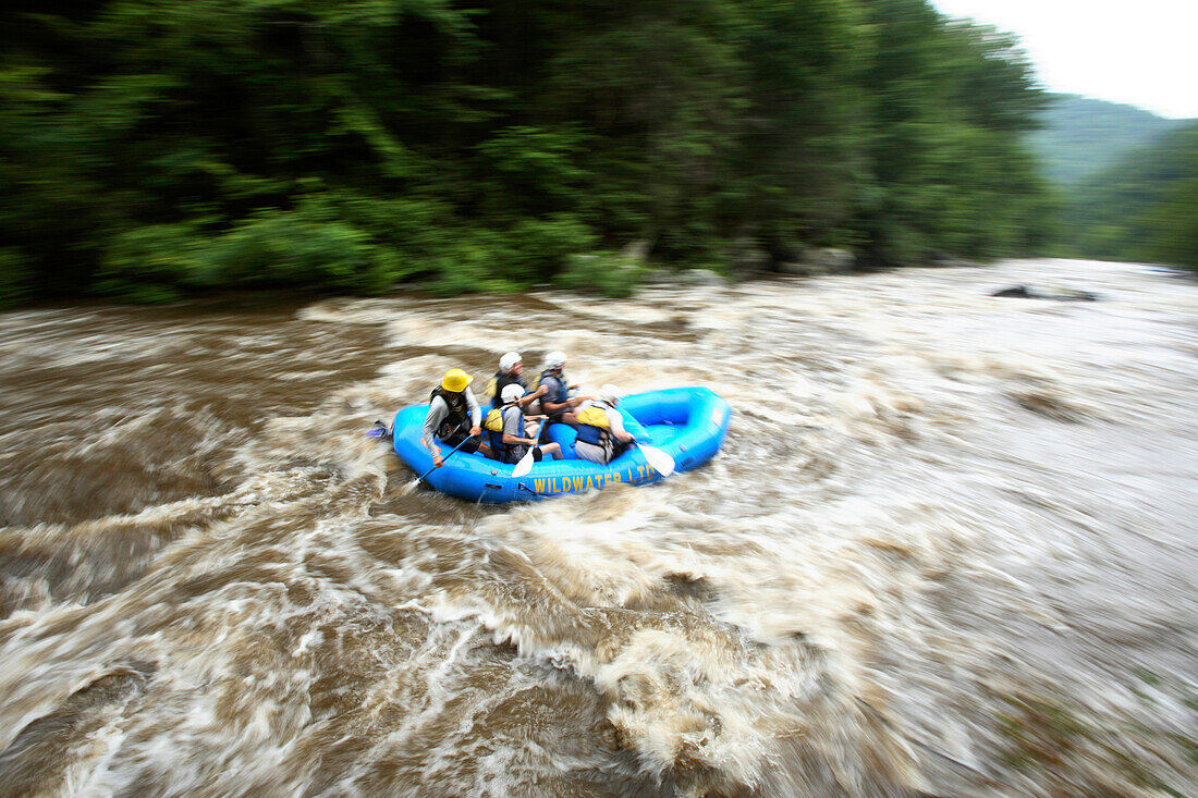 Zoom blur image of unknown rafters running the Cheoah River near Robbinsville, NC. This river was only recently opened to whitewater enthusiasts and only runs a few days each spring and fall when the gates at Santeetalh Dam are opened.