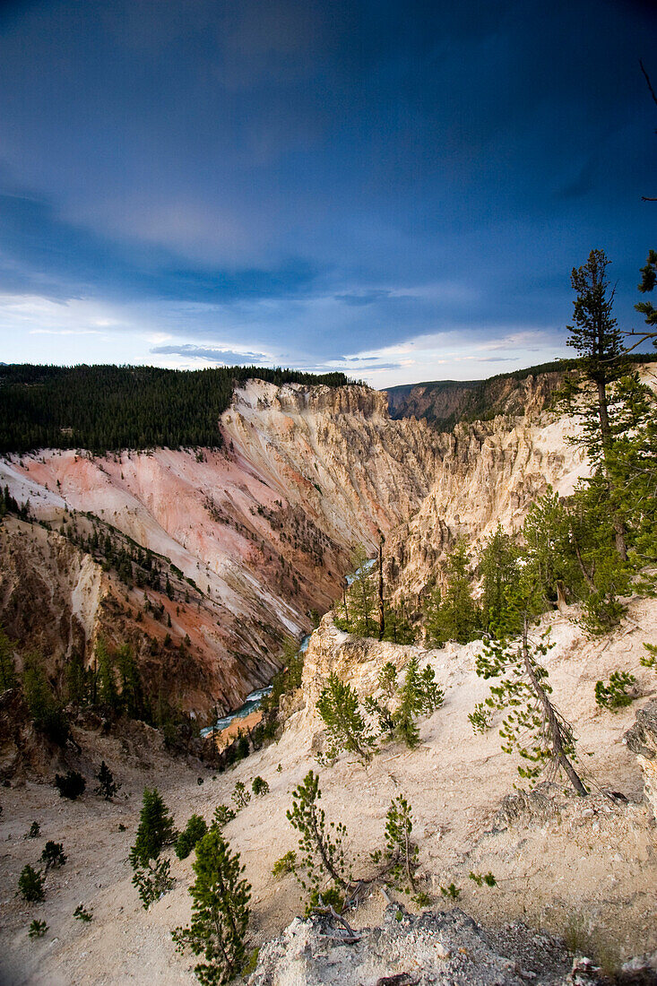 The grand canyon of the Yellowstone River in Yellowstone National Park, Wyoming is starkly majestic with pink rock and thick clouds overhead on July 22, 2005.