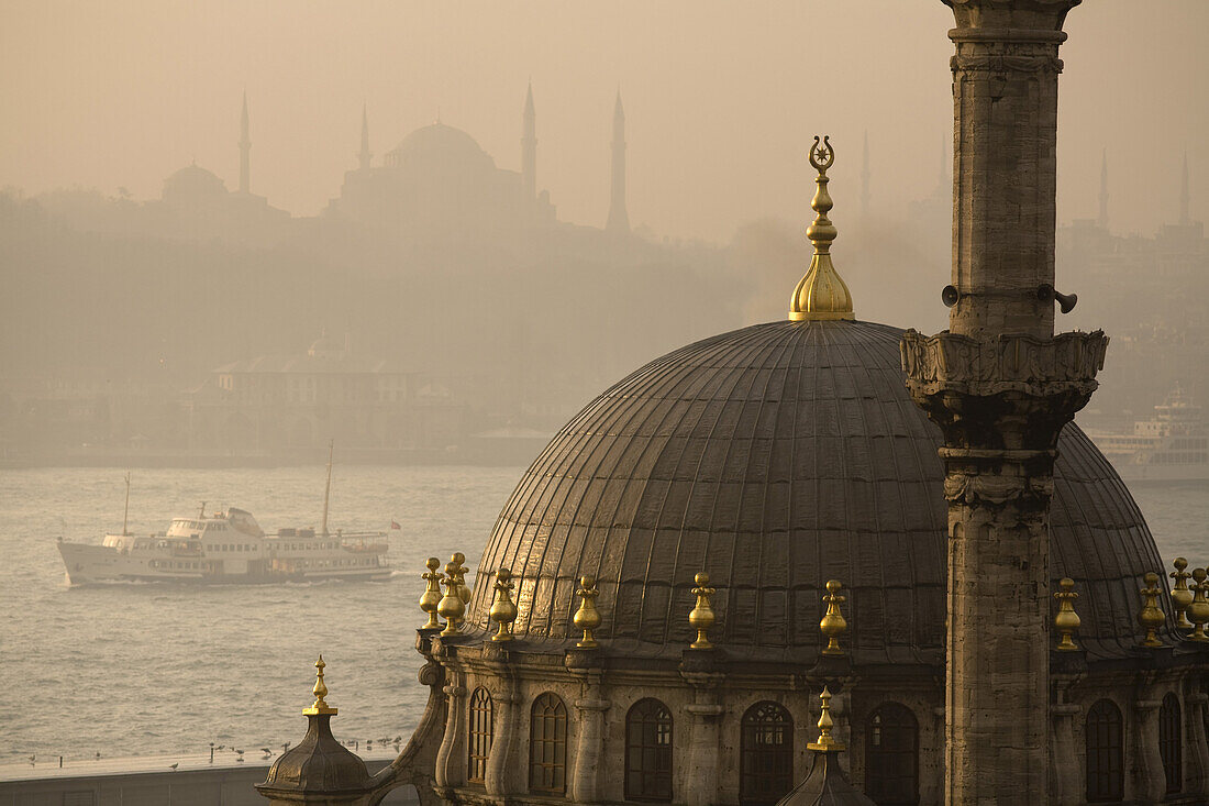 Istanbul, Turkey - January, 2008: Nusretiye Mosque in Istanbul overlooking the Golden Horn at sunrise with the Blue Mosque on the horizon.