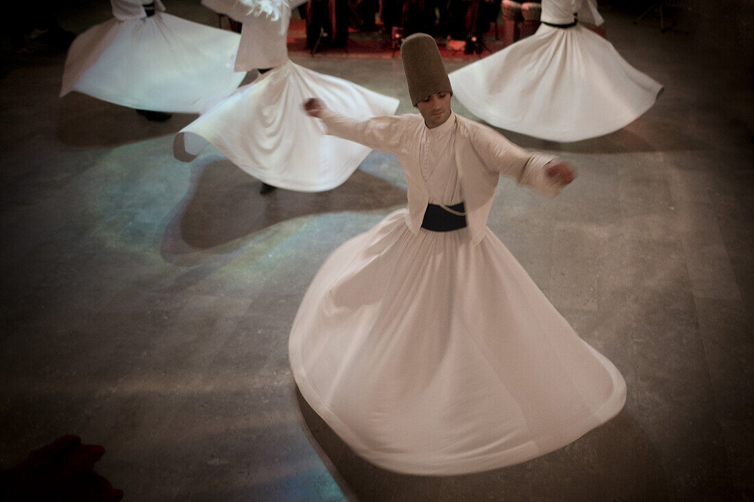 Istanbul, Turkey - January, 2008: The brotherhood of followers of Rumi known as Mevlevi or Whirling Dervishes perform their distinctive religious ceremony in Istanbul, Turkey. Rumi is famous for his poetry and religious writing and lived in the 13th centu