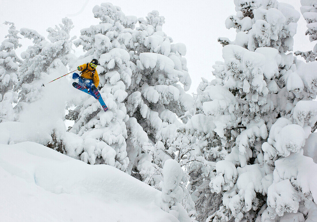 Skifahrer jumping through the deeply snowed in forest, Kaltenbach, Zillertal, Austria