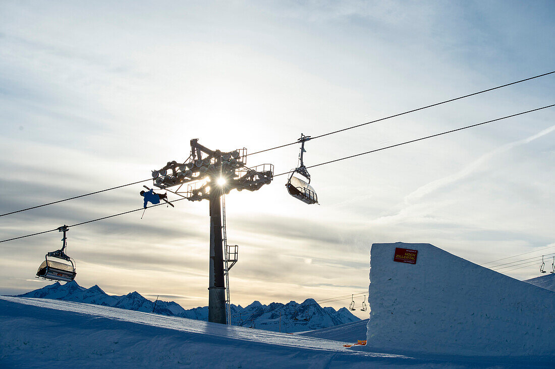 Skier jumping over big kicker in fun park, Betterpark, Kaltenbach, Zillertal, Austria