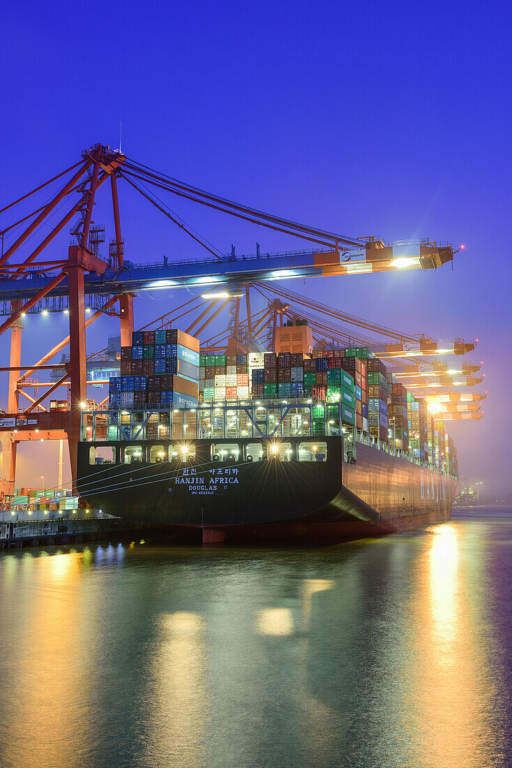 Container ships at illuminated container terminal Burchardkai at night, Waltershof, Hamburg, Germany