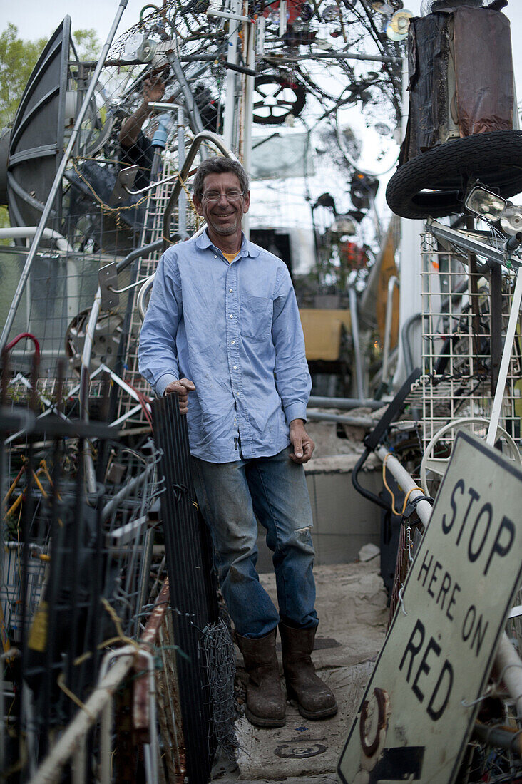 Vince Hannemann, creator of the Cathedral of Junk, poses at the upper story which was being closed off to appease city code.