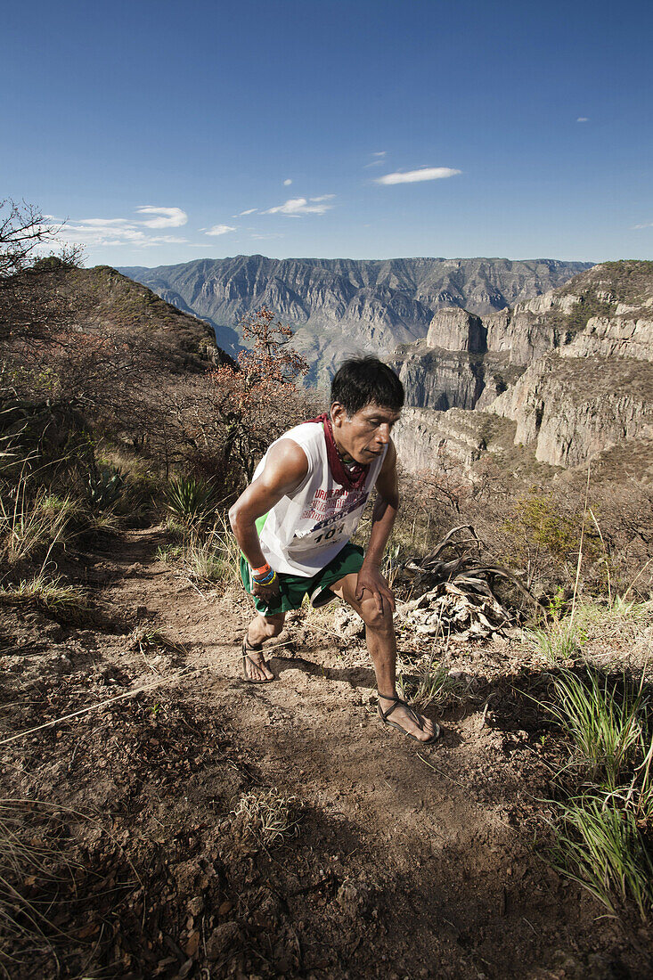 Tarahumara runner gets out of the Sinforosa canyon after a long climb at the kilometer 50 of the Ultramaraton de los Canones in Chihuahua, Mexico.