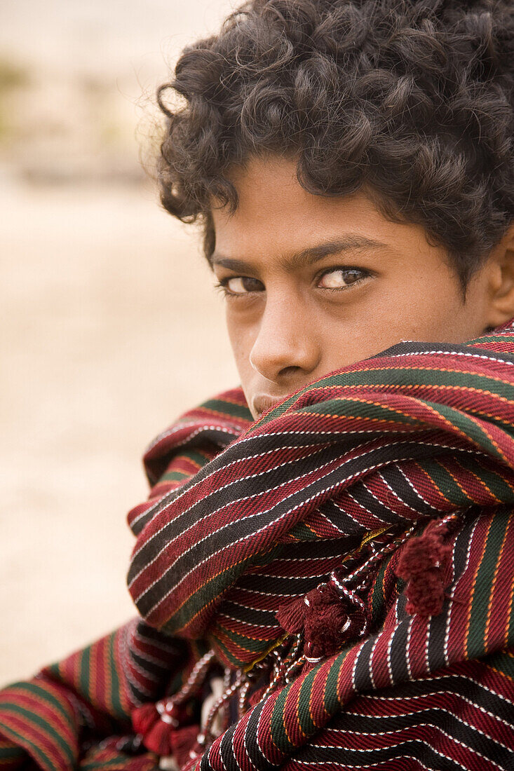 Portrait of a young bedouin boy, Jabal Samhan, Oman.