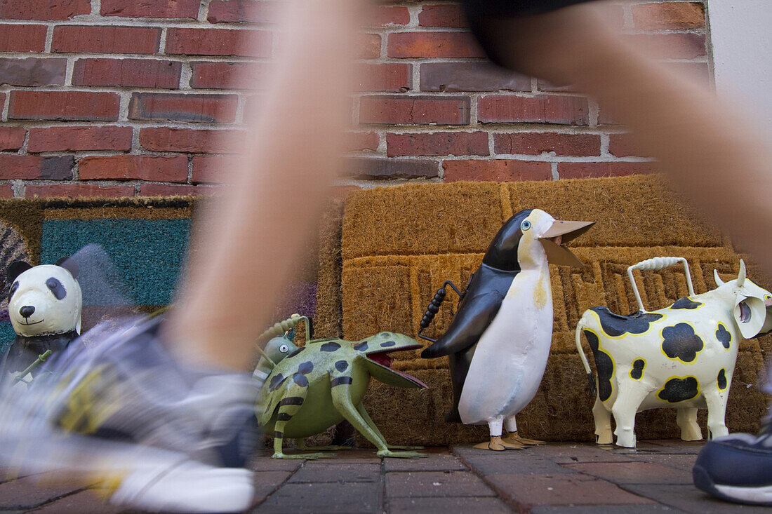 Shoppers walk past eclectic items for sale near Exchange Street in Portland, Maine's Old Port district.