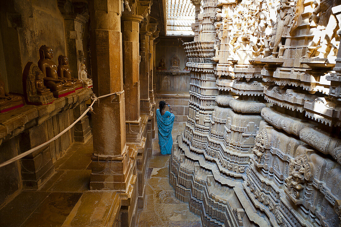 A woman in sari in a Jain Temple in Jaisalmer Fort, India.