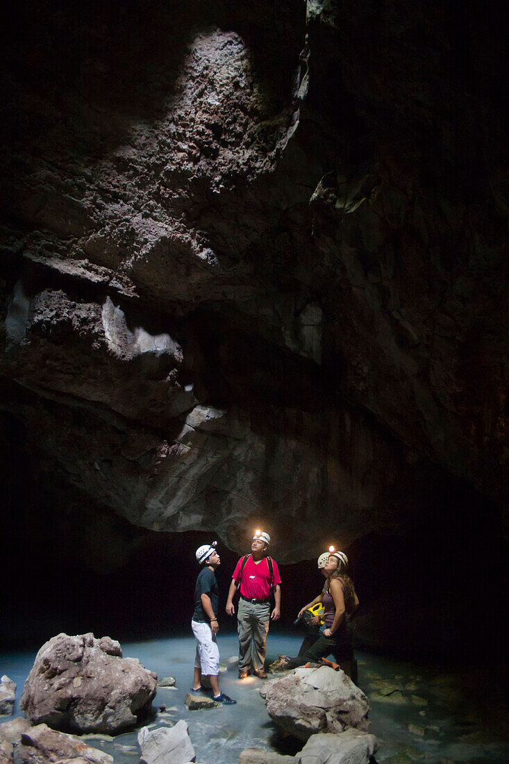 Four people exploring a cave in Tabasco,  Mexico.