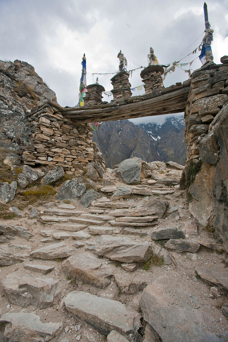 Gateway chortens to Naar Phu Valley, with khata and Buddhist prayer flag Lungta, offering. Manang, Nepal.