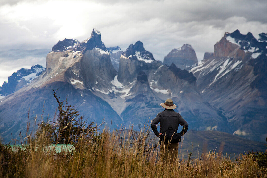 TORRES DEL PAINE NATIONAL PARK, PATAGONIA, CHILE. Hikers enjoy one of the best national parks in South America on a sunny day. With steep peaks full of hanging glaciers and glacial silt-filled lakes, Torres del Paine is one of the greatest attractions on 