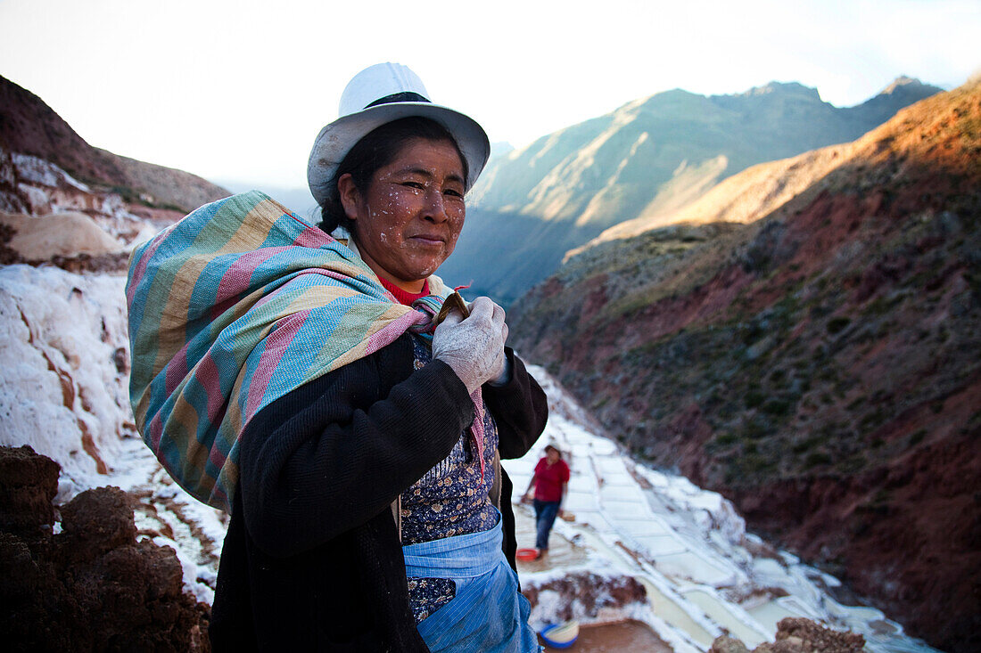 OLLANTAYTAMBO, SACRED VALLEY, PERU. A portrait of a woman looking at the camera after working in the salt pools near Maras in the Sacred Valley of Peru.