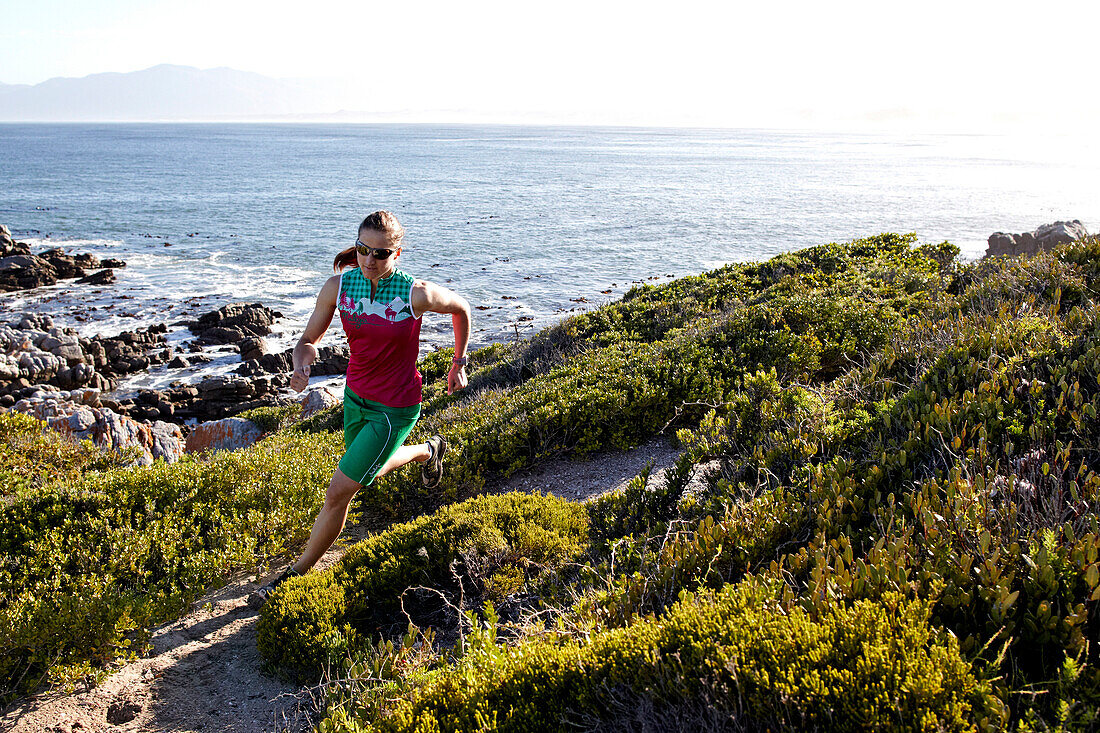 Susann Scheller running on an ocean trail between Gansbaai and De Kelders. South Africa.