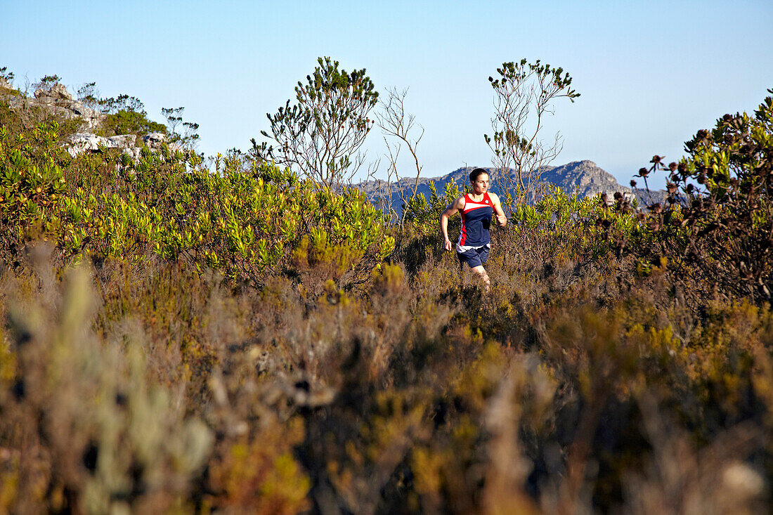 Susann Scheller running an a dusty trail near Silvermine in Table Mountain National Park near Cape Town. South Africa.