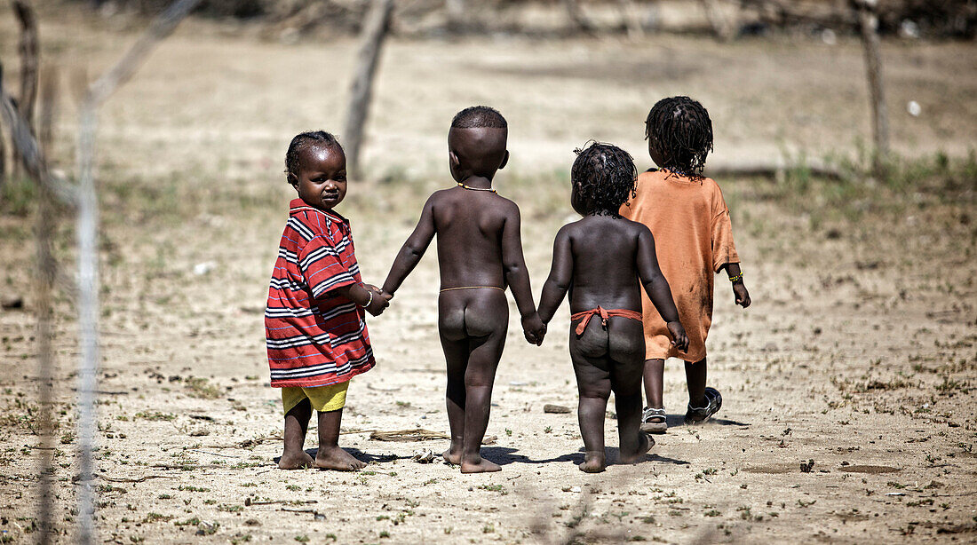 Young children from the Arbore tribe going for a walk, this small tribe lives in the Weyto Valley Desert living in a very harsh physical environment.Arbore tribe, Weyto Valley Desert, South Ethiopia, 2010